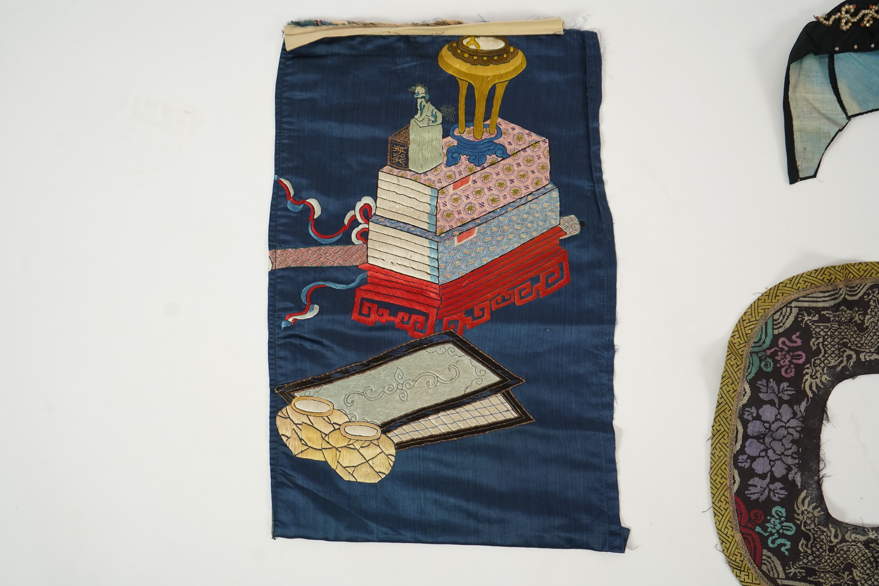 Two Chinese embroidered silk wedding skirts, late Qing, five hats, trousers, two skirt panels and two others, collar and a panel